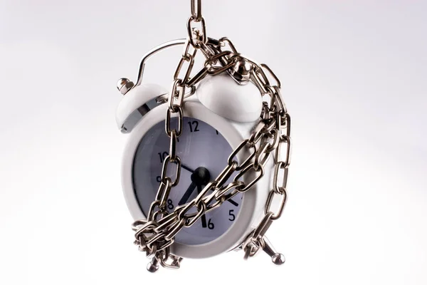 Alarm clock in chain — Stock Photo, Image