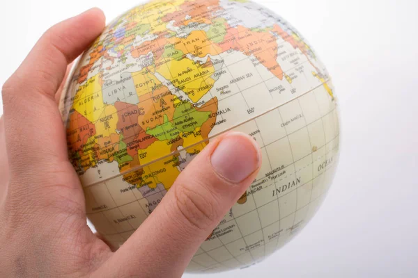 Hand holding a globe  with the map on it