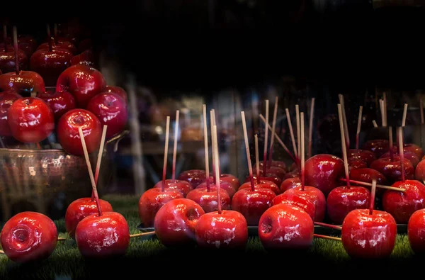 Candy apples are whole apples covered in a sugar candy coating w