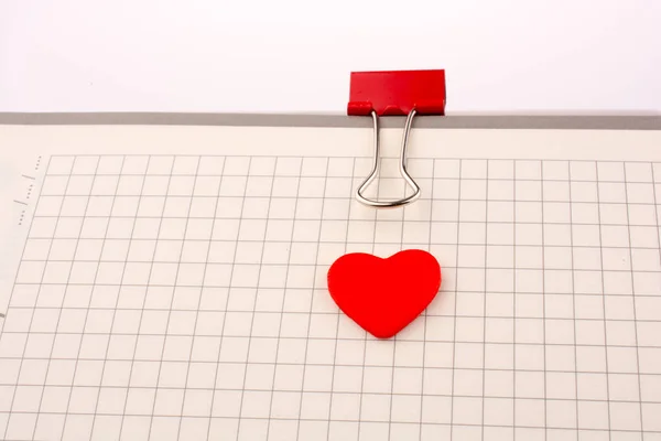 Red Heart on checked notebook