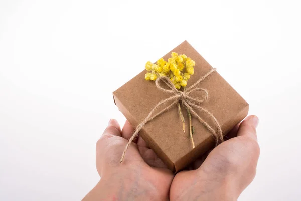 Gift Box with Flowers in hand — Stock Photo, Image