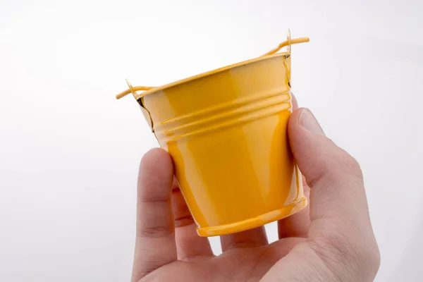 Hand holding a bucket — Stock Photo, Image