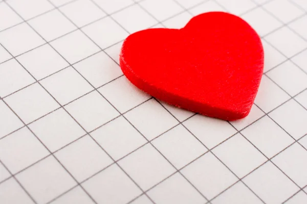 Red Heart on checked notebook