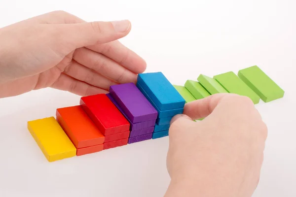 Mano jugando con dominó de colores —  Fotos de Stock