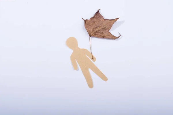 Man shape cut out of paper on ground