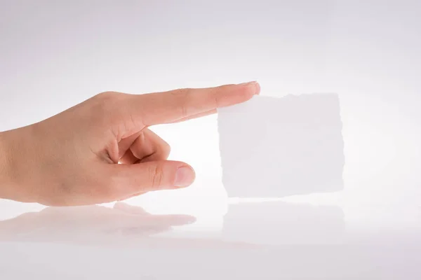 Mão segurando um pedaço de papel — Fotografia de Stock