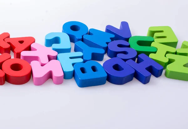 Colorful letter blocks scattered randomly on white — Stock Photo, Image