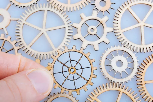 Gear wheel in hand on white background as concept of engineering — Stock Photo, Image