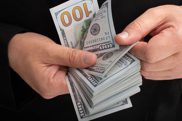 Businessman holding US dollar banknote money
