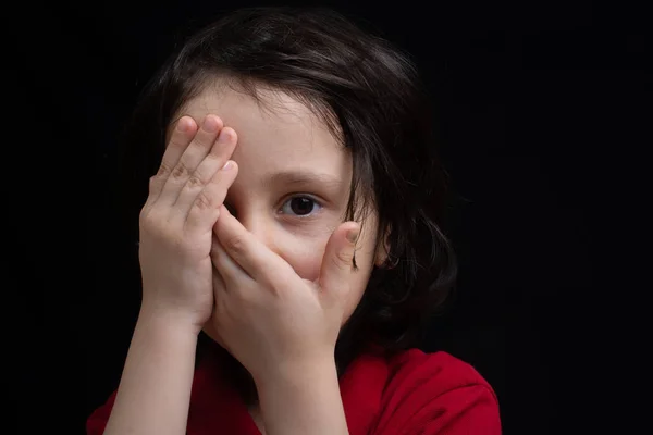 Little boy peeking covering face and one eye with hand — Stock Photo, Image