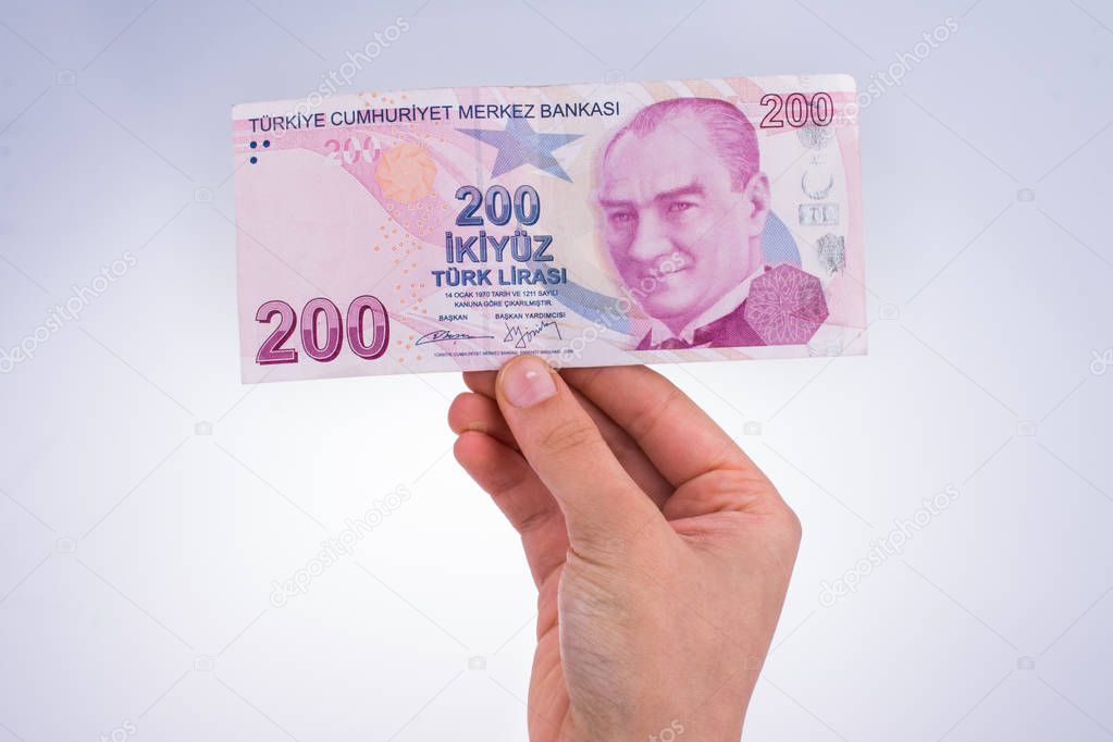 Hand holding Turksh Lira banknote in hand