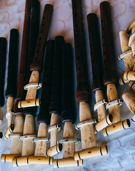 Dozens of handmade wooden flutes in display