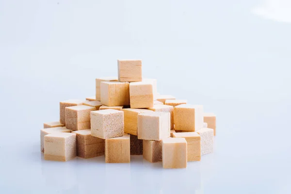 Wooden toy cubes as  educational game object on white background