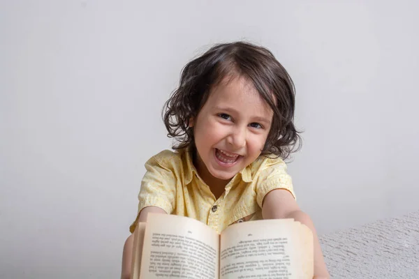 Menino segurando livro como conceito Dia Mundial do Livro — Fotografia de Stock