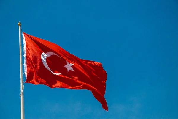 Turkish national flag with white star and moon in sky — Stock Photo, Image
