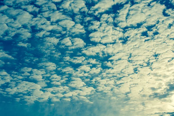 Gray color clouds partly cover the  sky