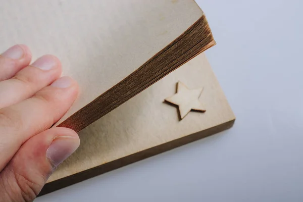 Hand holding a book with a star in pages — Stock Photo, Image