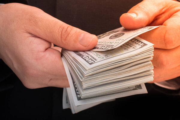 Businessman holding US dollar banknote money