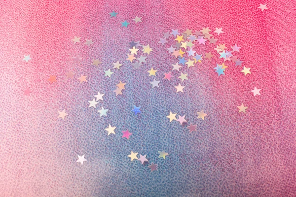 Colorful confetti stars on a colorful background