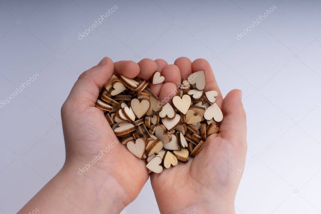 Handful of Retro style wooden hearts  on white background