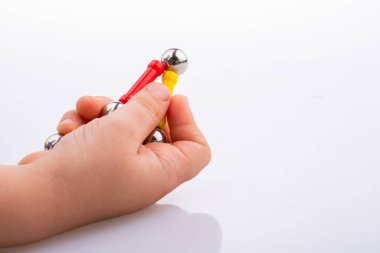 Beyaz arkaplanda mıknatıs oyuncak çubukları ve manyetik toplar var.
