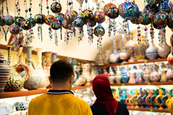 Interior view of the Grand Bazaar.  Tourists shopping in the Grand Bazaar.