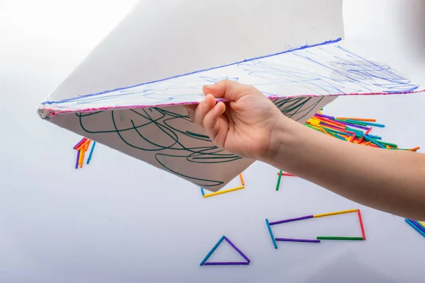 Hand holding paper plane in hand as creative concept