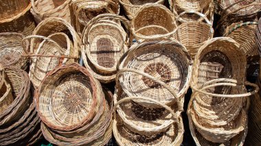 Empty wicker baskets are for sale in a market place clipart