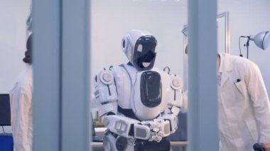 İki kişi robotlar durumu incelemek.