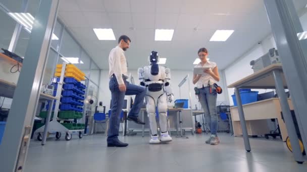 Robot blanco copia los movimientos de un hombre . — Vídeos de Stock