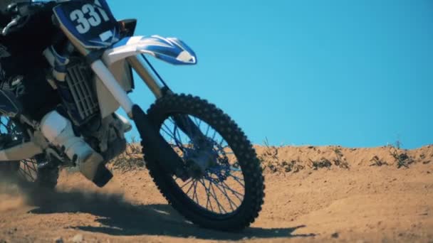 Clouds of dust are getting raised after a motorcycle driving through terrain — Stock Video