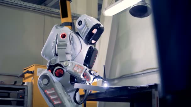 Industriële robot is permanent in een fabriek eenheid en lassen. — Stockvideo