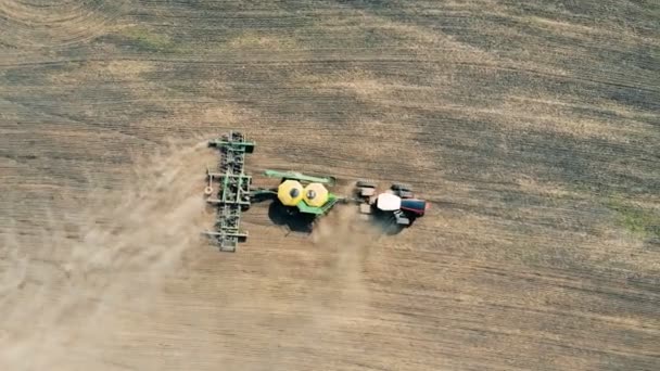 Meadow is getting scattered with seeds by a field engine — Stock Video