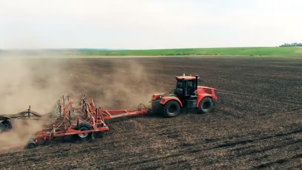Scenic field is getting sown by a field truck. Aerial drone shot of a farmer in tractor seeding, — Stock Video