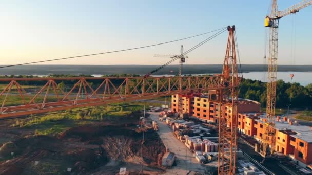 High construstion cranes on a construction site. 4K Aerial shot — Stock Video
