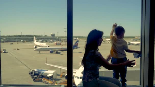 A family wait for their flight at the airport lounge. — Stock Video