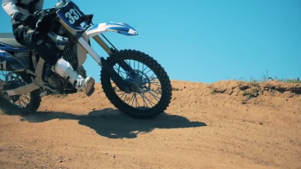 Motorbike is being driven across an offroad terrain. Slow motion — Stock Video