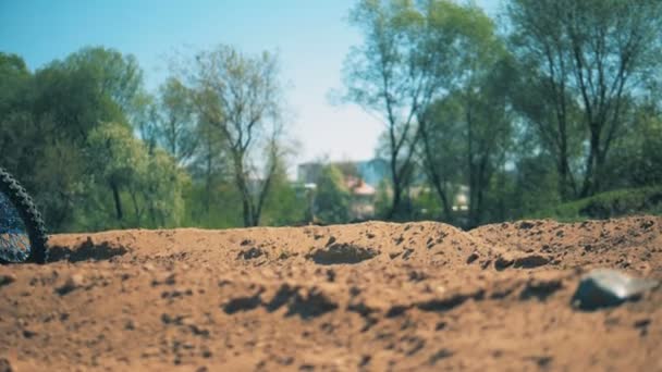 Мотоцикл мчится по песчаной местности в замедленной съемке — стоковое видео