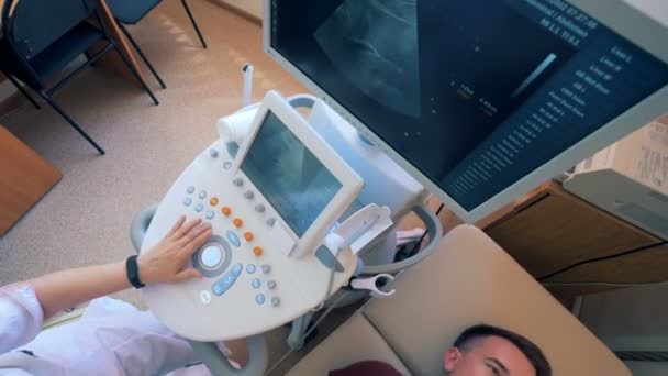 Procedimento de ultrassom realizado em um paciente masculino por um médico — Vídeo de Stock