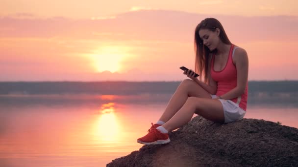 Kvinna i ett myggor moln ser på sin telefon. 4k. — Stockvideo