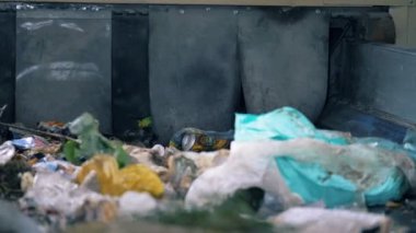 Bir işçi çöp bir satıra sıralar, yakın çekim. Fabrika işçisi bir konveyör çöp ile belgeleri alır.