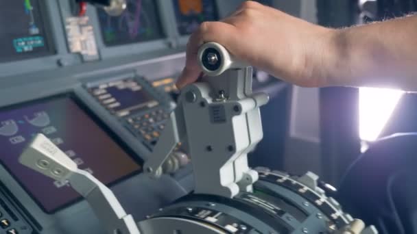 Close up of airplane pilots hand regulating thrust lever handle for engine control during flight. — Stock Video