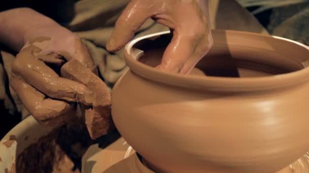 Un alfarero usa una esponja mientras gira un jarrón sobre una rueda. 4K . — Vídeos de Stock