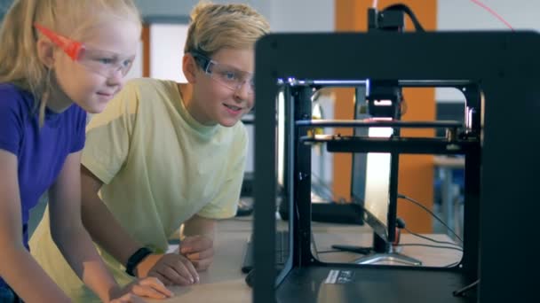 Kids are observing a process of 3D printing — Stock Video