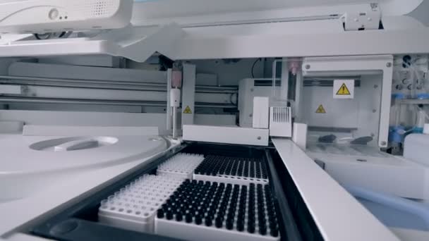 Provrör väntar bearbetning av en biokemisk analys maskin — Stockvideo