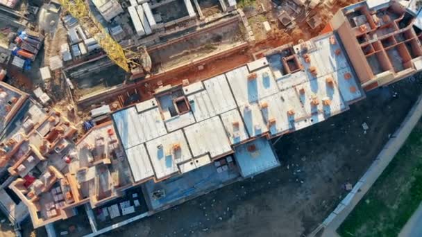 Bâtiment inachevé et une grue, vue de dessus, aérien . — Video