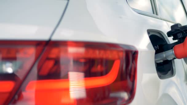 White car with a fuel pistol being inserted into its tank. Gasoline, gas, fuel, petroleum concept. — Stock Video