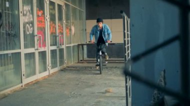 BMX hileci performans terk edilmiş bir binada bir genç tarafından
