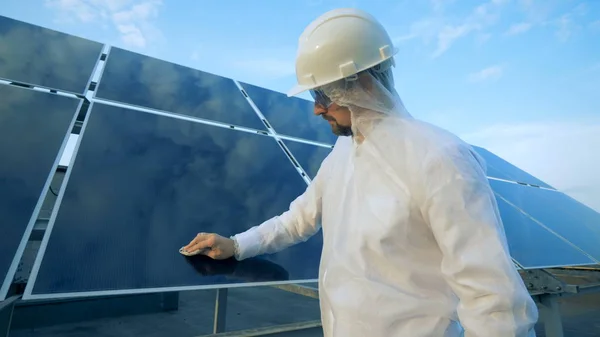 Erkek mühendis güneş paneli temizler.