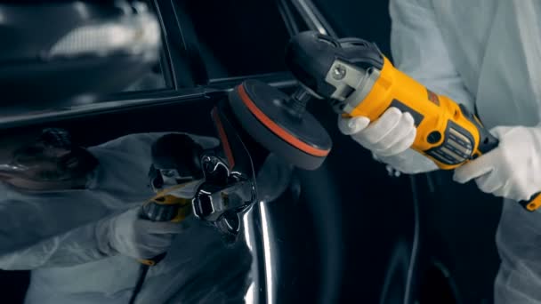 Person using polishing tool on a car, close up. — Stock Video